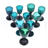 A matched set of ten late Georgian Bristol green stemmed wine glasses with tulip bowls and plain