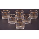 A set of six 19th century glass wine glass rinsers with faceted bodies, decorated with gilt scrolls,