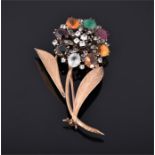 A yellow metal and multi gem floral brooch, the flower set with tigers eye, agate, citrine, etc.