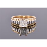 A yellow metal and diamond gents ring having single square cut stone of approx. 2.0 carats,