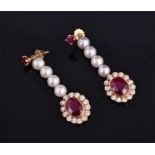 A pair of 18 carat yellow gold, diamond, ruby, and pearl metamorphic earrings suspended with diamond