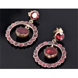 A pair of yellow metal, garnet, and red paste circular drop earrings, the butterflies stamped 9ct.