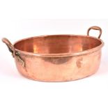 A large Victorian copper preserve pan having iron ring and rolled edge, copper riveted bell metal