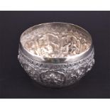 An Indian silver circular bowl decorated all around with panels of dancing figures. Diameter, 10cm