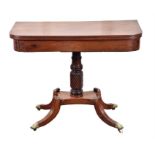 A Regency mahogany fold-over tea table the plain top with moulded edge and supported on a turned