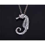 A handmade solid silver seahorse pendant with rose cut diamond eye, realistically modelled,