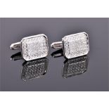 A pair of 18 carat white gold and diamond set cufflinks of chamfered rectangular form, pave set with