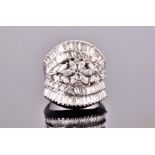 An impressive white metal and diamond cocktail ring with central floral cluster of round and