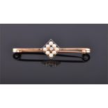 A 15 carat yellow gold, diamond, and seed pearl bar brooch. L: 4.5cm Weight, 2.4g