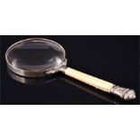 A Victorian silver mounted and ivory magnifying glass hallmarked London 1880, the ivory handle