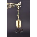 A Victorian brass spit roasting bottle jack with key with hanging platform and suspended from an