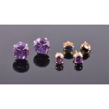 A pair of yellow metal and Alexandrite ear studs each set with single round cut stone, the