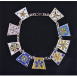 A fine quality silver and polychrome enamel necklace set with nine colourful enamel panels, and S-