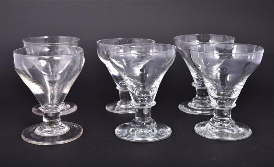 A near set of six Georgian pan top clear glass rummers with sloped sides and conical feet circa