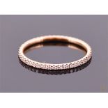 A Georg Jensen 18 carat rose gold and diamond set 'Aurora' eternity ring set with small diamonds of