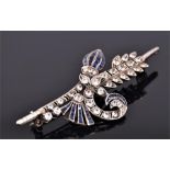 An early 20th century white metal, blue and white sapphire set floral spray brooch, set with round