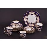 A Royal Crown Derby tea set comprising six cups and saucers, tea plates, and a sandwich plate,