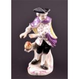 A 19th century Furstenberg porcelain figure of a traveller stood warming his hands by a flame,