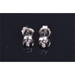 An unusual pair of handmade silver and diamond skull-shaped ear studs.