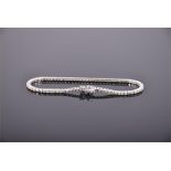 An 18 carat white gold and diamond line bracelet, having round cut stones of approx. 2.0 carats