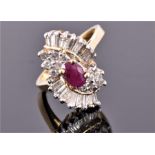 A 14 carat yellow gold, diamond, and ruby cluster cocktail ring, centred with an oval cut ruby,