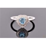 A 9 carat white gold, diamond, and aqua blue topaz heart-shaped halo cluster ring, having heart-