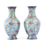 A pair of early 20th century Chinese cloisonné vases of baluster form, decorated with flowers on a