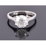 A large diamond solitaire ring set in white metal, either 18ct white gold or platinum, the round cut