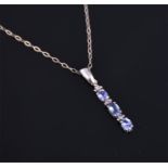 A 9 carat white gold, tanzanite, and diamond pendant suspended on a 9 carat white gold chain.