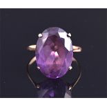 A 14 carat yellow gold and Alexandrite ring having oval cut central stone measuring 18 x 13mm.