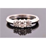 An 18 carat white gold and diamond three stone ring, having graduated round cut stones of approx.