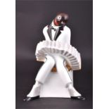 An Art Deco style ceramic figure of 'The Accordianist' by Villeroy & Bosch dated 1991,