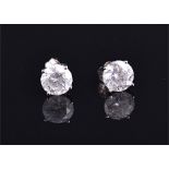 A pair of 18 carat white gold and solitaire diamond ear studs set round cut stones of approx. 3.0