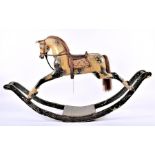 A late 19th century painted rocking horse with auburn mane and tail, dapple painted, with later