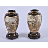 A pair of Japanese Satsuma vases c.1900  decorated with scenes of families in mountainous