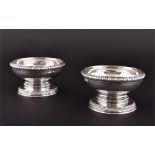 A pair of George III silver salt cellars London 1781, by Paul Storr, each globular bowl on a