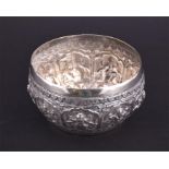 An Indian silver circular bowl decorated all around with panels of dancing figures. 10 cm diameter.