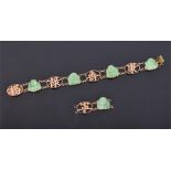 A 14ct yellow gold and Chinese green jade bracelet set with carved jade segments in the form of a