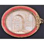 An Indian late 19th century oval ivory panel of an interior of a prominent Mogul palace set in a red