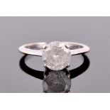 A white metal mounted solitaire diamond ring set with a round cut diamond of approximately 2.0