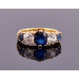 An 18ct yellow gold, diamond and sapphire five stone ring set with two old cut diamonds of