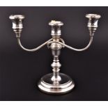 A 20th century silver three-light candelabra with two scrolling branches and central candle