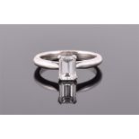A platinum and diamond ring set with an emerald-cut diamond weighing approximately 1.0 cts,