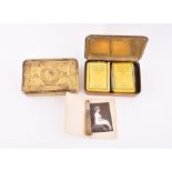 Two WWI 1914 Christmas tins one containing tobacco, cigarettes, a Christmas card and a photograph of