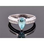 An 18ct white gold, diamond and apatite ring set with a pear cut apatite, the tapered shoulders