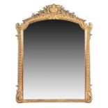 A large Victorian gilt gesso over mantel wall mirror  with floral shell surmount, the finely