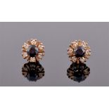 A pair of 18ct yellow gold, diamond and sapphire cluster earrings of circular form, each centred