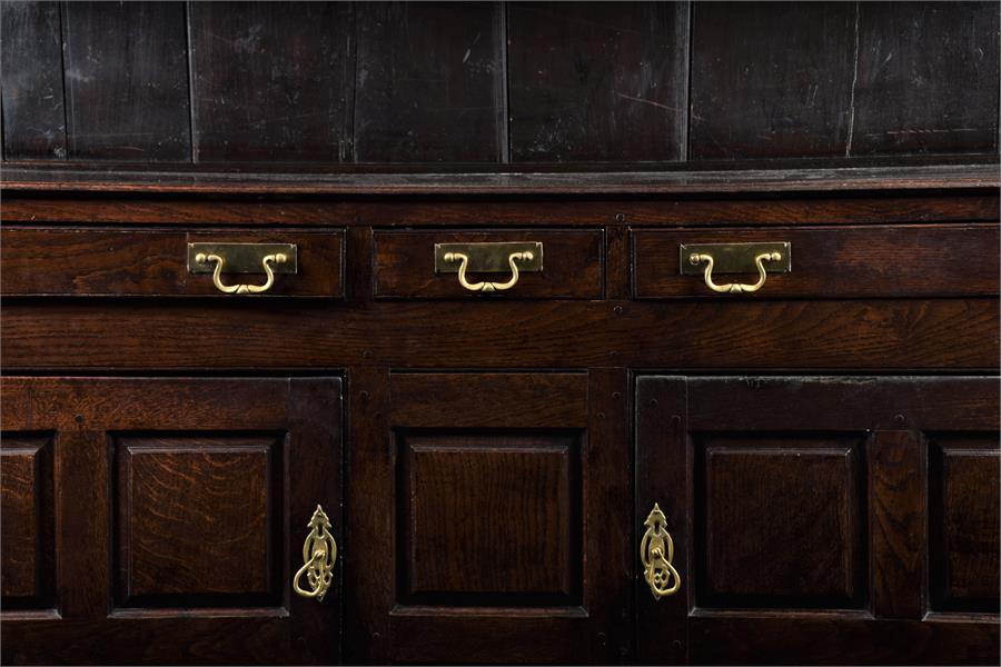 An 18th century Welsh oak dresser with three drawers above two panelled cupboard doors opening to - Image 2 of 2