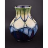 A modern Moorcroft baluster vase with purple, blue and green/cream tube lined decoration, marked