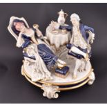 A Royal Dux Bohemia porcelain group entitled 'Afternoon Tea'  of a couple in conversation over
